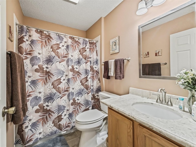 bathroom with tile patterned floors, vanity, toilet, and a textured ceiling