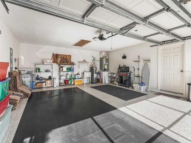 garage with a garage door opener and electric water heater