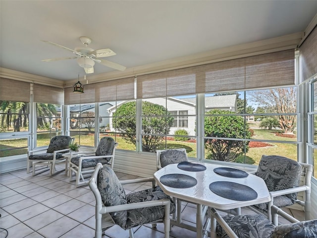 sunroom / solarium featuring ceiling fan