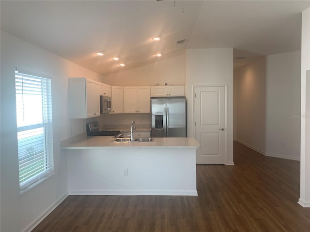 kitchen featuring white cabinetry, kitchen peninsula, appliances with stainless steel finishes, dark hardwood / wood-style flooring, and sink