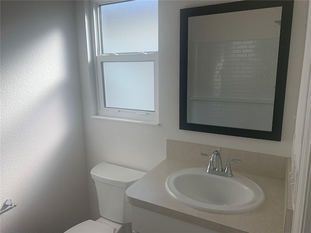 bathroom featuring toilet and vanity