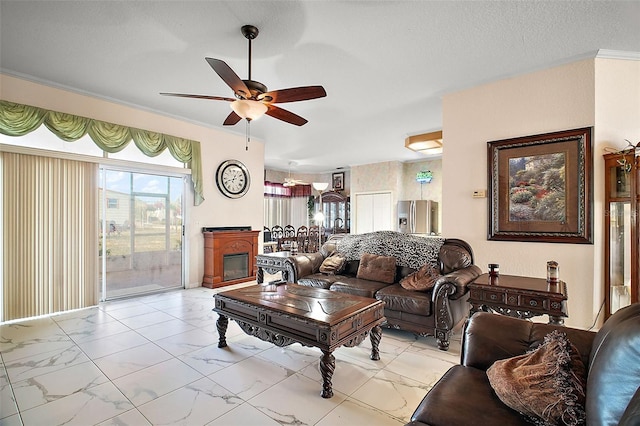 living room with a textured ceiling, ceiling fan, and crown molding