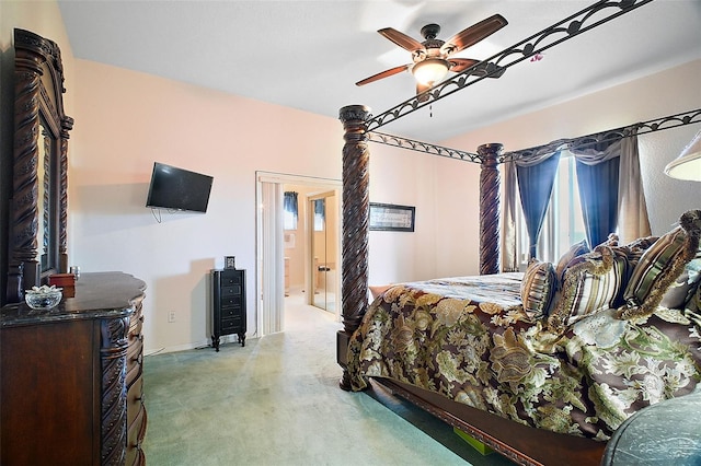 bedroom featuring ceiling fan, ensuite bath, and light carpet