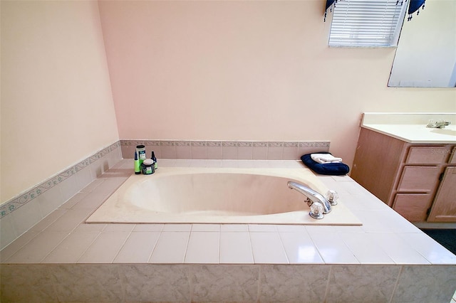 bathroom featuring vanity and tiled tub