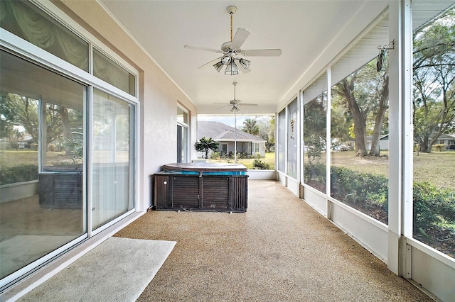 unfurnished sunroom featuring ceiling fan