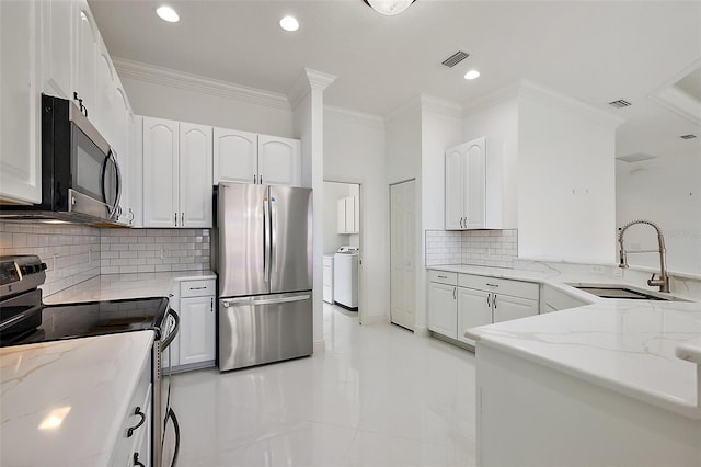 kitchen featuring light stone countertops, white cabinets, and stainless steel appliances