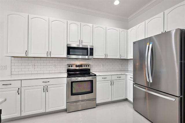 kitchen with stainless steel appliances, white cabinetry, crown molding, and backsplash