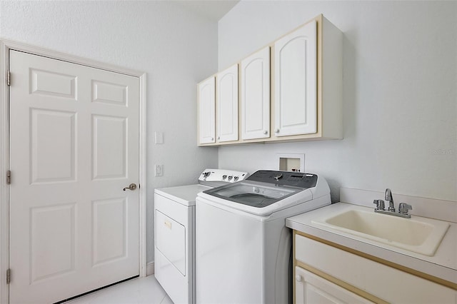 laundry area featuring cabinets, sink, washing machine and dryer, and light tile patterned flooring