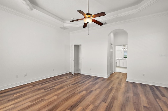 spare room featuring crown molding, dark hardwood / wood-style floors, and a tray ceiling