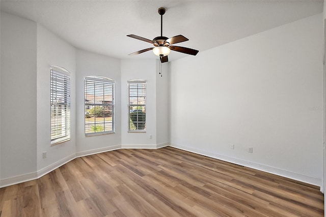 unfurnished room with hardwood / wood-style flooring and ceiling fan