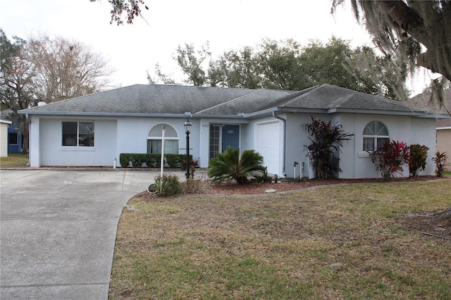 ranch-style home featuring a front yard and a garage