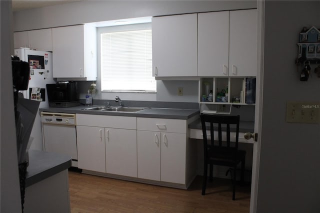 kitchen featuring light wood-type flooring, dishwasher, sink, and white cabinetry