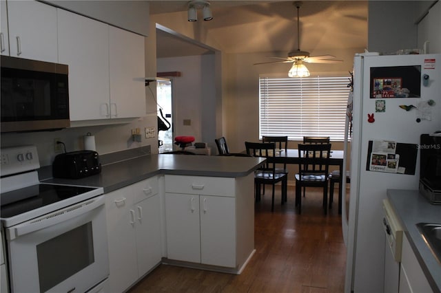 kitchen featuring ceiling fan, dark hardwood / wood-style floors, kitchen peninsula, white appliances, and white cabinets