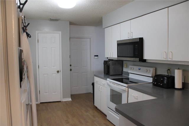 kitchen with light hardwood / wood-style floors, a textured ceiling, white cabinets, and white electric range