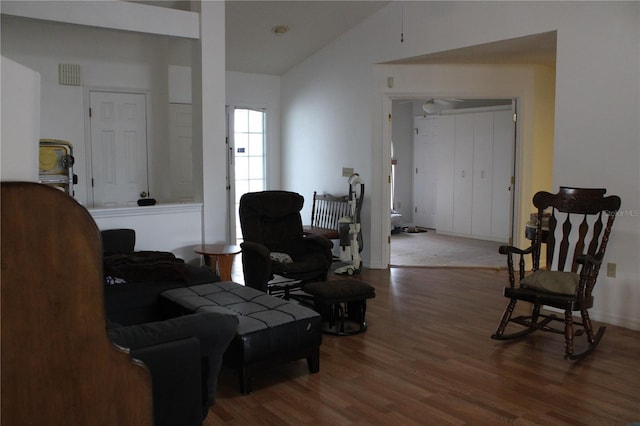 living room featuring hardwood / wood-style floors and vaulted ceiling