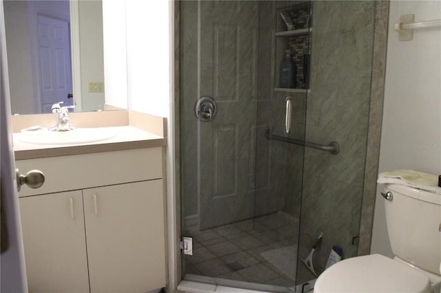 bathroom with toilet, walk in shower, and vanity