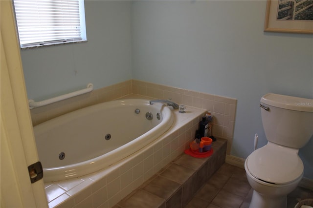 bathroom featuring toilet, tile patterned floors, and tiled bath