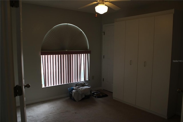 unfurnished bedroom with ceiling fan and carpet flooring