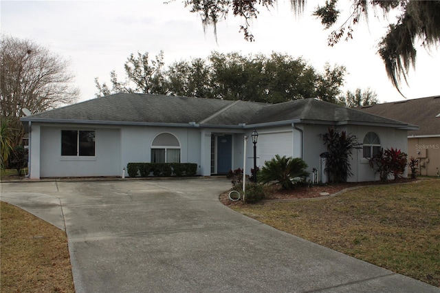 ranch-style home with a front yard and a garage