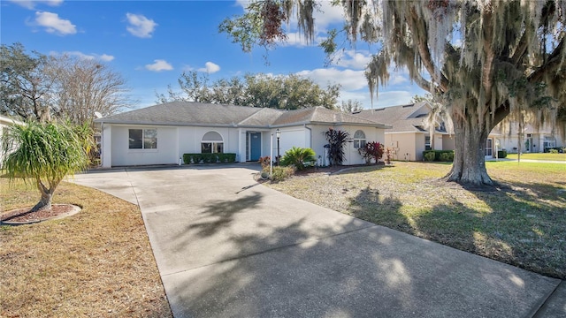 single story home featuring a garage and a front lawn