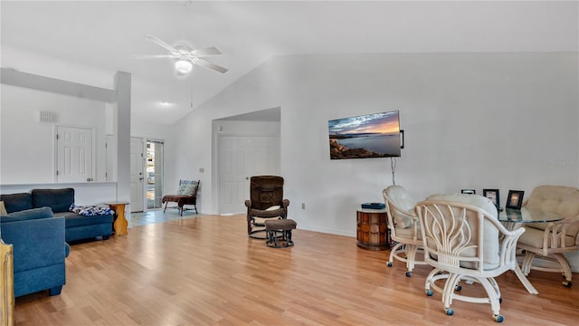 living room featuring lofted ceiling, light hardwood / wood-style flooring, and ceiling fan