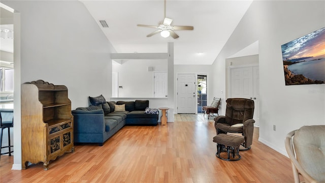 living room with vaulted ceiling, ceiling fan, and light hardwood / wood-style flooring