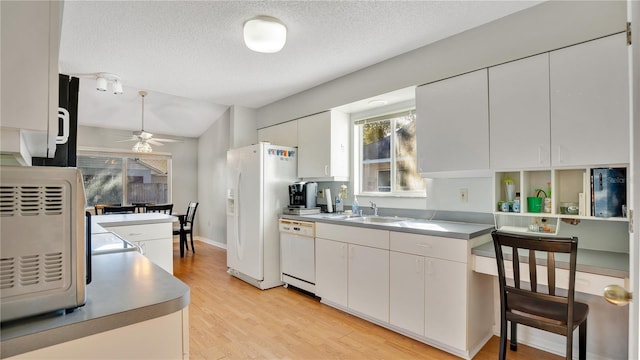 kitchen with sink, white cabinets, ceiling fan, white appliances, and light hardwood / wood-style flooring