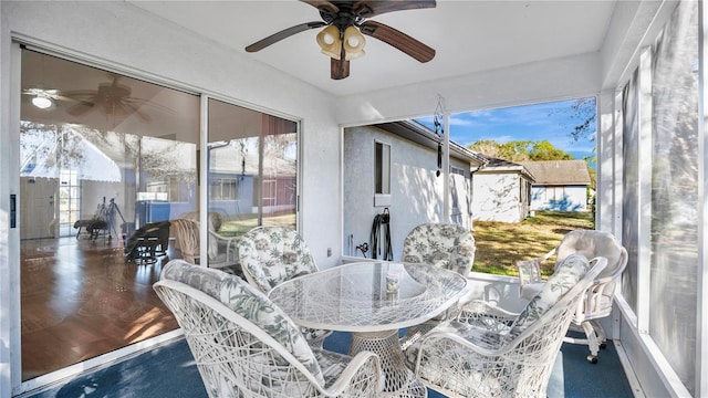 sunroom / solarium with plenty of natural light and ceiling fan