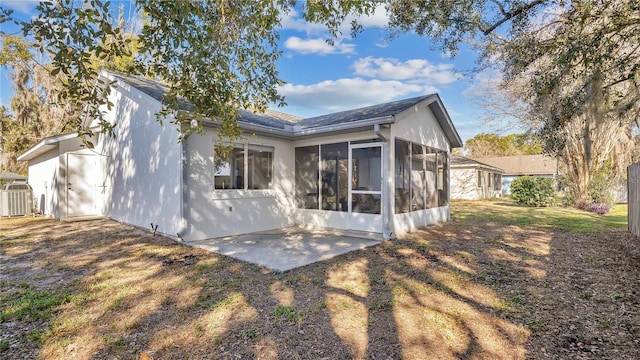 rear view of house with cooling unit, a patio, and a sunroom