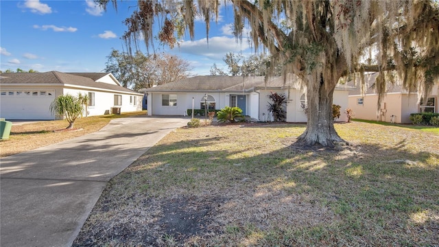 ranch-style house with a garage and a front lawn