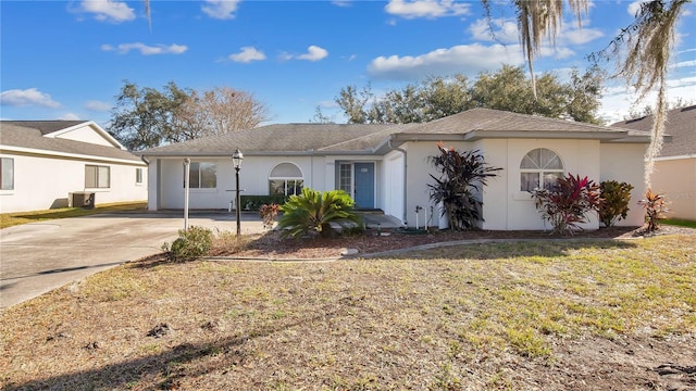 ranch-style house featuring central AC unit and a front lawn