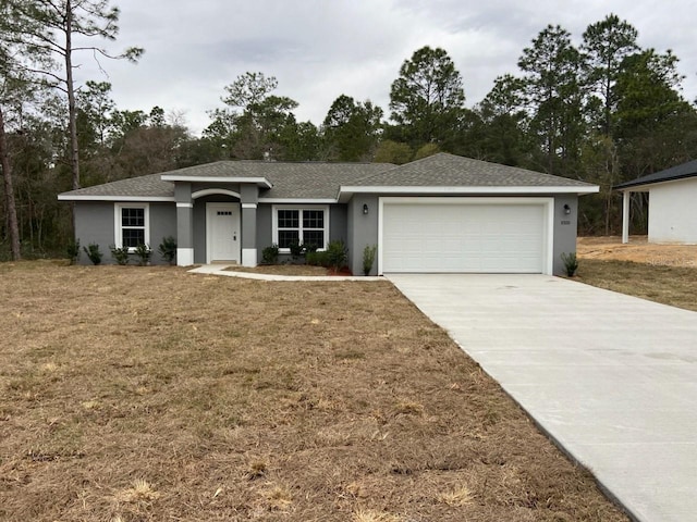 ranch-style home featuring a front lawn and a garage