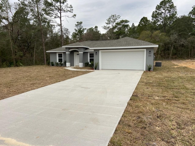 ranch-style home with a front lawn and a garage