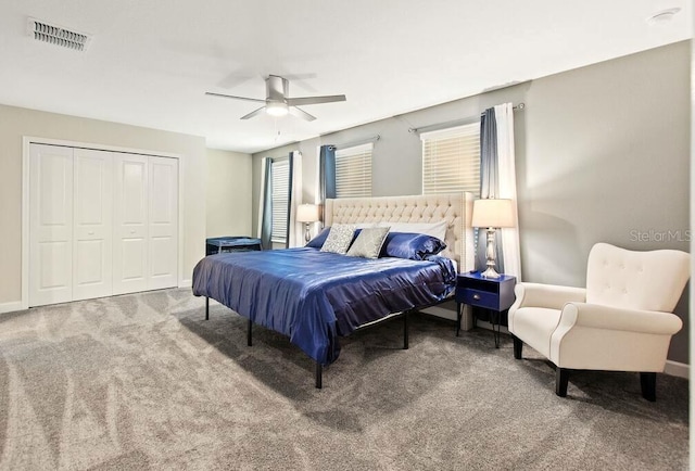 bedroom with ceiling fan, a closet, and carpet flooring