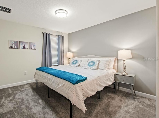 bedroom featuring a textured ceiling and carpet flooring