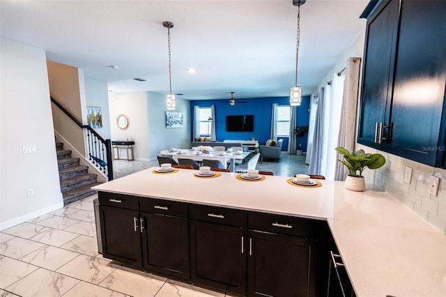 1257 Challenge Dr, Davenport, FL 33896 - kitchen with open floor plan, a peninsula, light countertops, and light marble finish floors