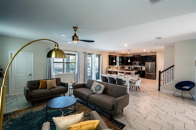 1257 Challenge Dr, Davenport, FL 33896 - living room with light marble finish floors, stairway, a ceiling fan, and recessed lighting