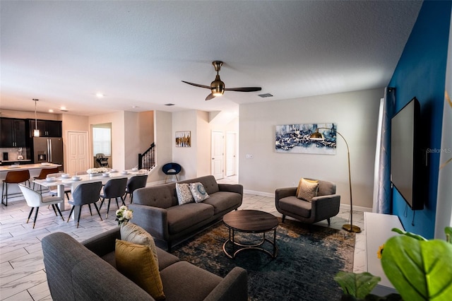 1257 Challenge Dr, Davenport, FL 33896 - living area featuring ceiling fan, light marble finish floors, stairway, and recessed lighting