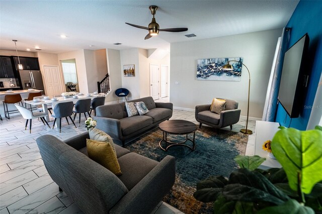 1257 Challenge Dr, Davenport, FL 33896 - living room with light marble finish floors, stairway, a ceiling fan, and recessed lighting