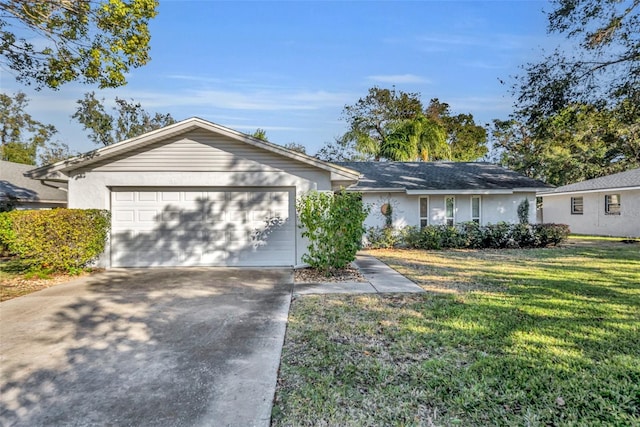 ranch-style house featuring a garage and a front lawn