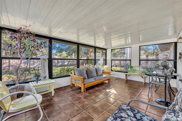 sunroom featuring wood ceiling and a wealth of natural light