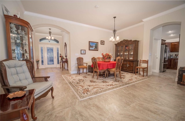 dining space with a chandelier and ornamental molding