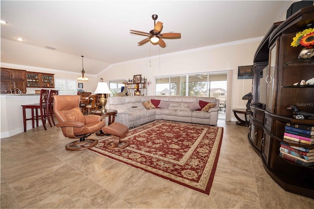 living room featuring ceiling fan, plenty of natural light, ornamental molding, and vaulted ceiling