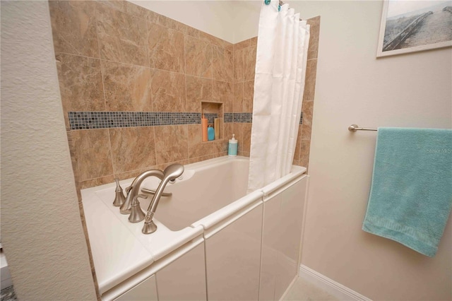 bathroom with shower / bath combination with curtain