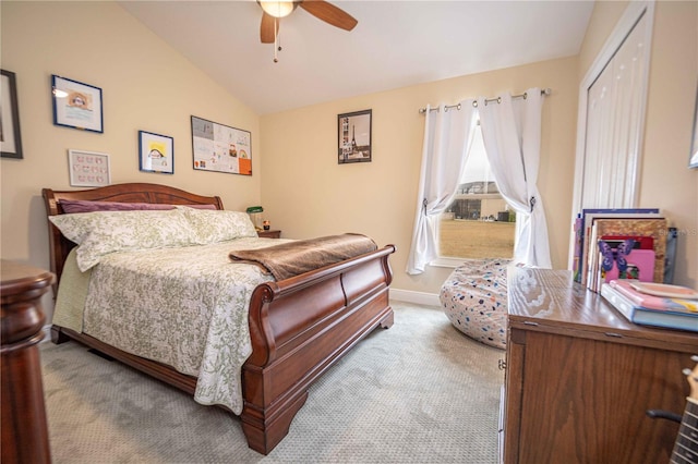 bedroom featuring ceiling fan, light carpet, a closet, and lofted ceiling