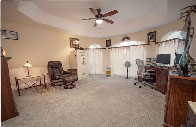 office area with ceiling fan, a raised ceiling, and carpet floors