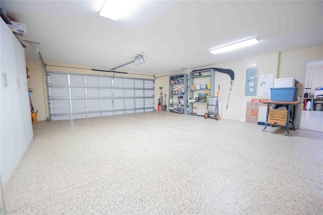 garage featuring electric panel and a garage door opener