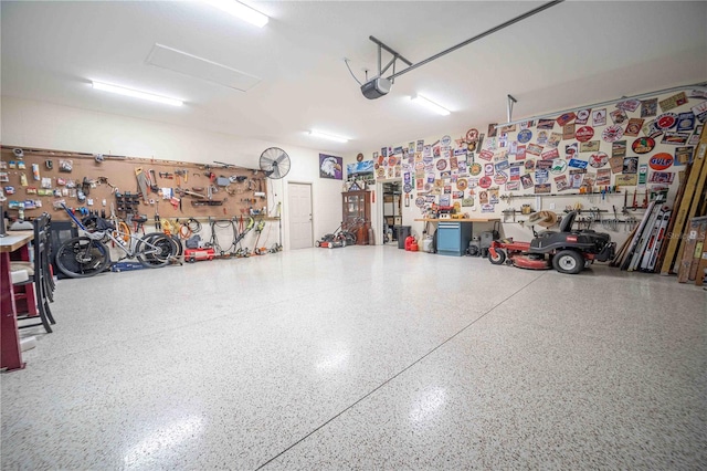 garage featuring a garage door opener and a workshop area