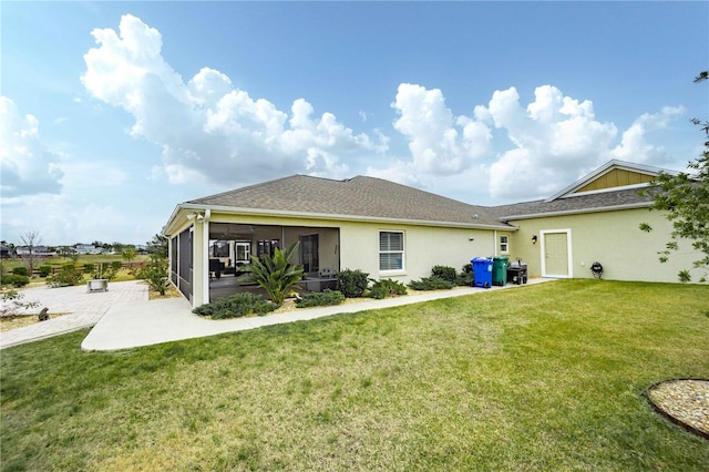 back of property featuring a yard and a sunroom