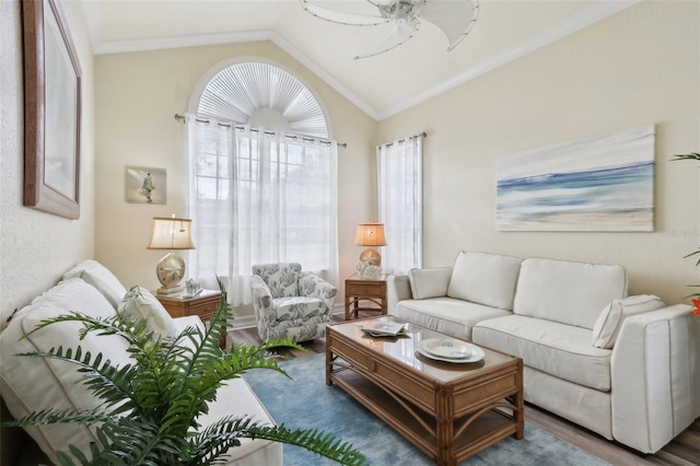 living room with vaulted ceiling, hardwood / wood-style floors, ceiling fan, and crown molding